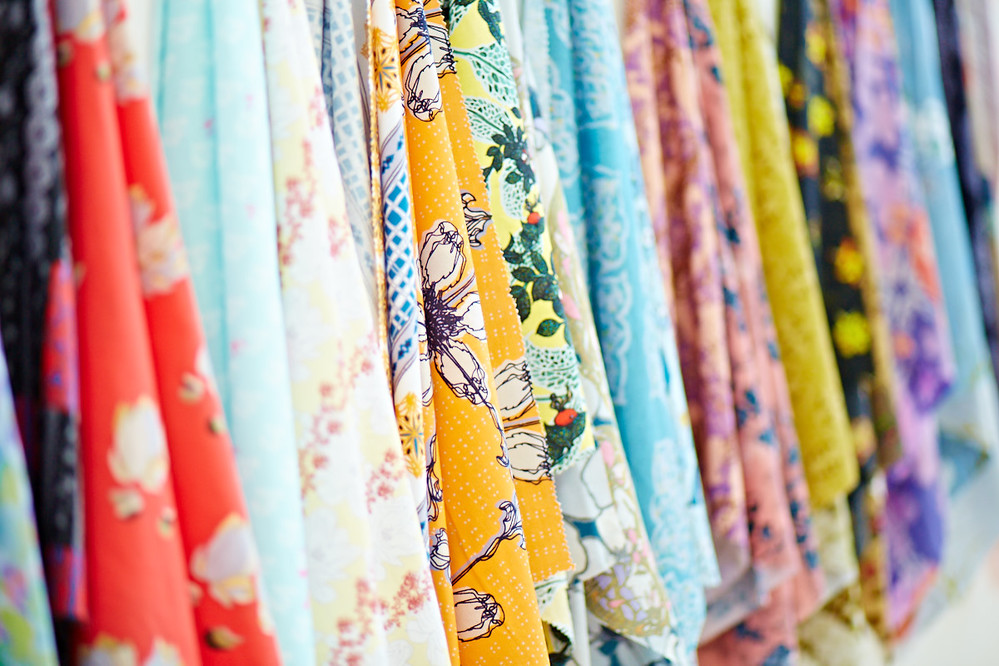 Brightly coloured fabric on racks