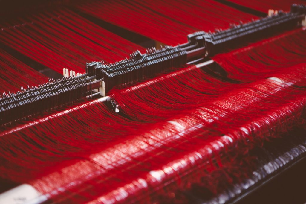 Red yarn on a loom