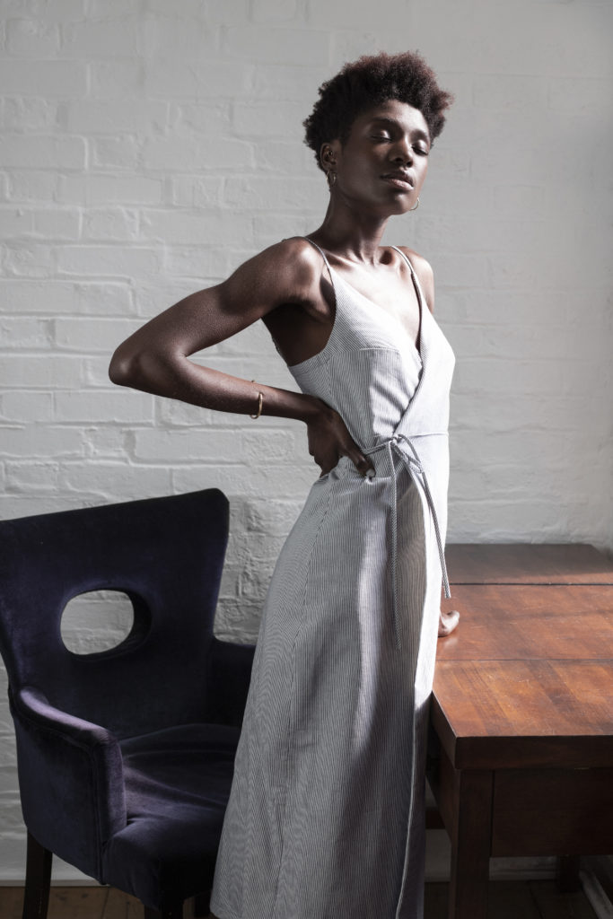 Model wears long grey wrap dress