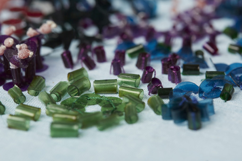 Green, purple and blue tubes and discs of translucent plastic