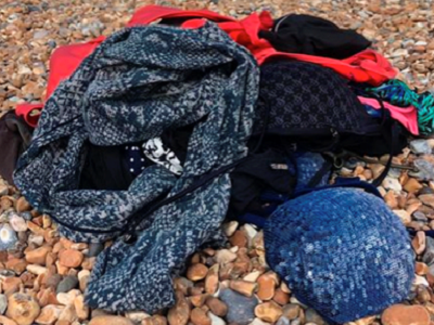 A pile of waste swimwear on a rocky beach